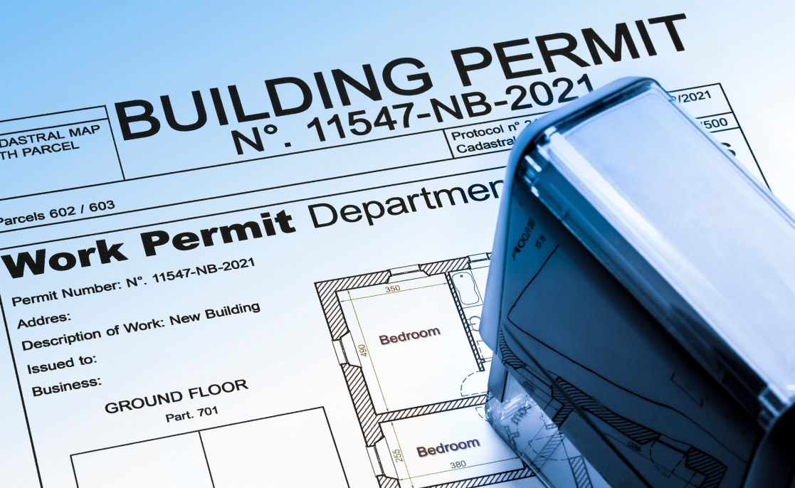 Buildings Permit concept with residential building project and plastic stamp