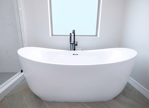 Spacious white bathtub in a stylish bathroom, highlighting luxury home upgrades and modern design elements.