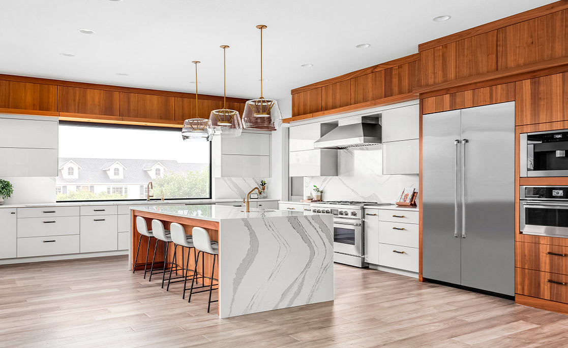 Spacious kitchen with a large island and sleek stainless steel appliances, perfect for prospective home builders or buyers.