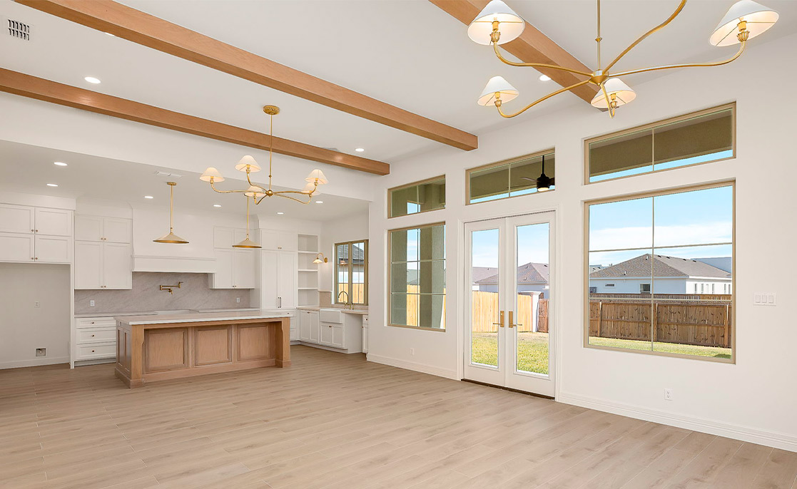 An expansive kitchen with hardwood flooring and a ceiling fan, illustrating the appeal of custom homes in Harlingen, TX.