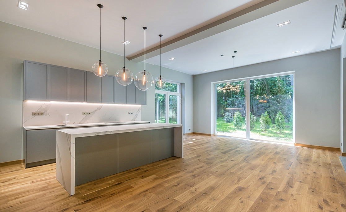Contemporary kitchen with wooden flooring and white cabinetry, showcasing key buyer preferences in McAllen and Harlingen.