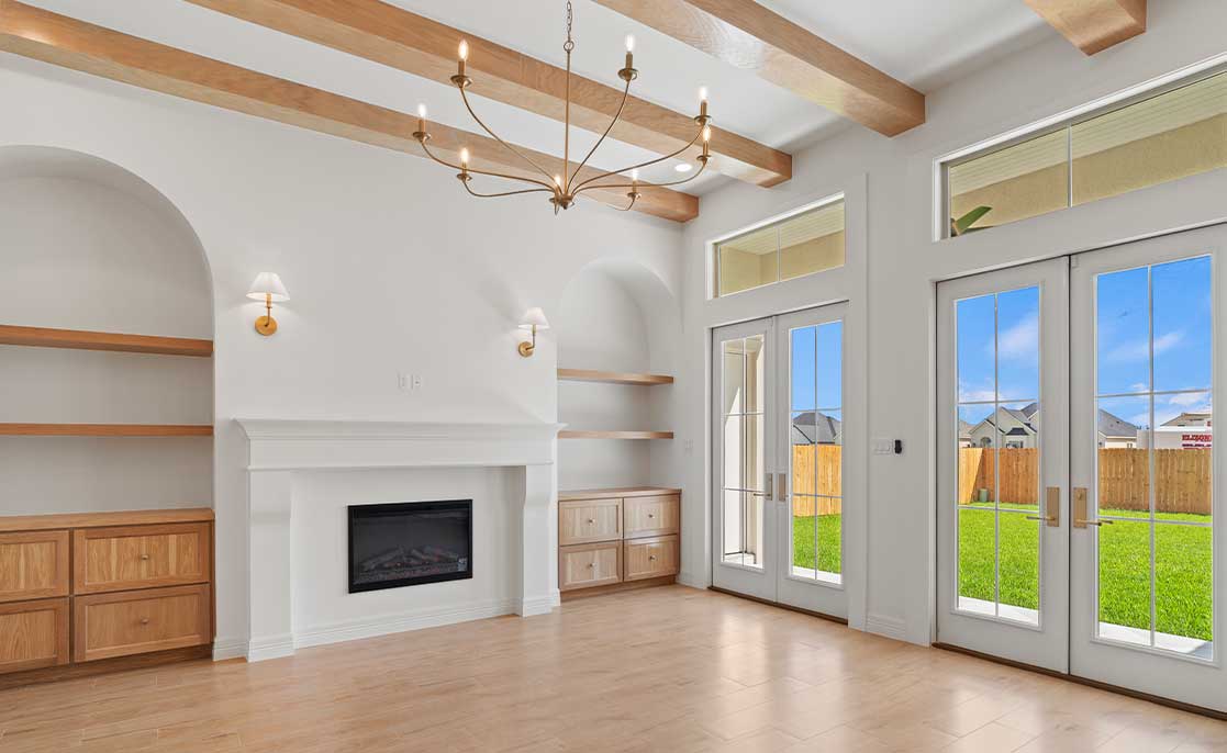  Spacious living room featuring a cozy fireplace and sliding glass doors, highlighting McAllen, Texas' desirable neighborhoods.