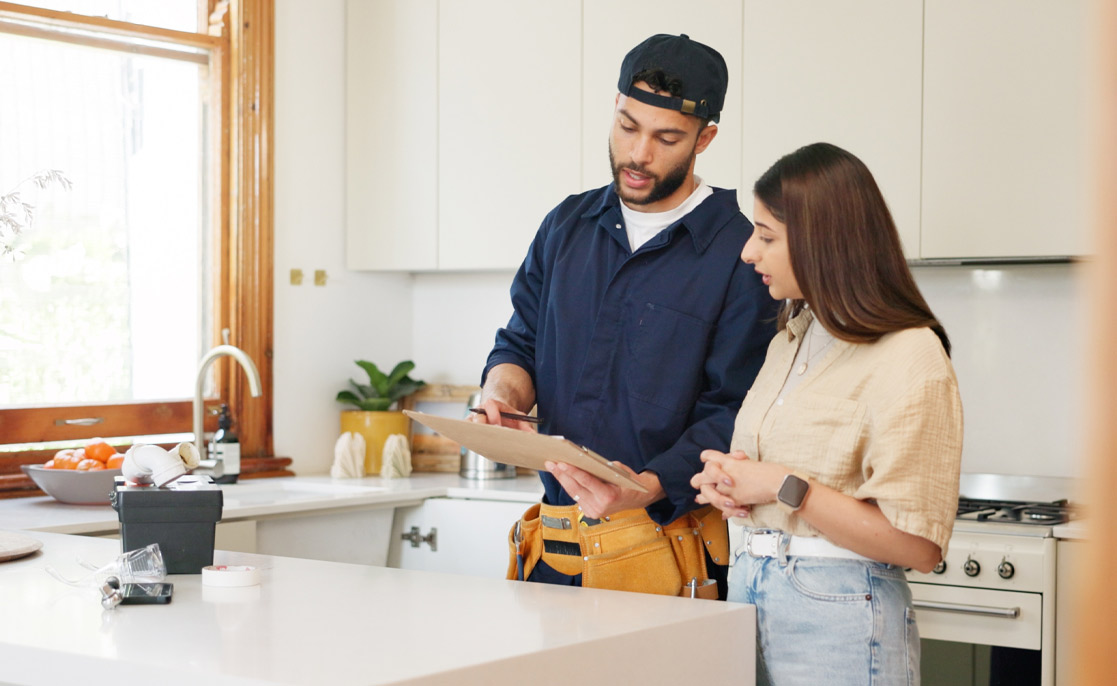 Woman, kitchen and plumber with contract on clipboard for maintenance service, information and repairs. House, discussion and man with notes in checklist for renovation, inspection or client feedback